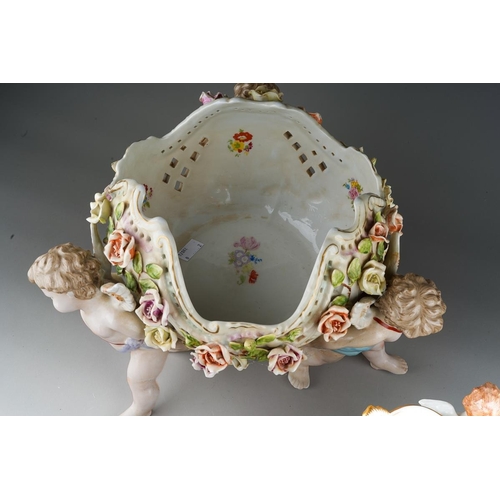 13 - A German porcelain large fruit bowl, the shaped bowl with diamond lozenge piercing applied with rose... 