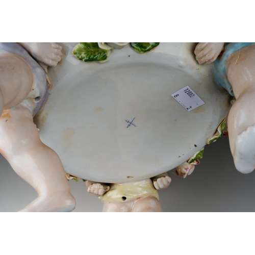 13 - A German porcelain large fruit bowl, the shaped bowl with diamond lozenge piercing applied with rose... 