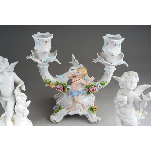 15 - A pair of Dresden Sitzendorf figural candelabra., the urn shaped sconces on scroll branches applied ... 