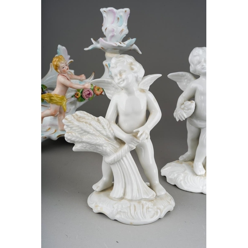 15 - A pair of Dresden Sitzendorf figural candelabra., the urn shaped sconces on scroll branches applied ... 