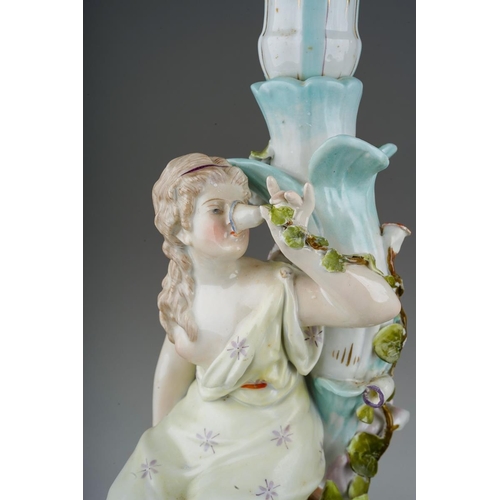 17 - A pair of early 20th Century Sitzendorf candlesticks modelled as seated Classical Maidens, tulip sha... 