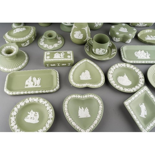 19 - A collection of green Wedgwood jasperware, including dwarf candlesticks, vases, pin dishes, coffee c... 