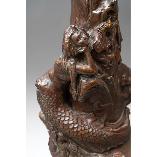 22 - A large Bretby brown painted vase modelled with a mermaid and iris flowers, carrying handle., stampe... 