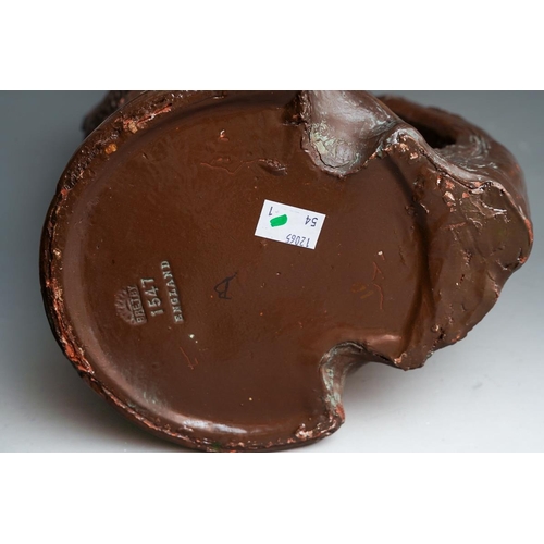 22 - A large Bretby brown painted vase modelled with a mermaid and iris flowers, carrying handle., stampe... 