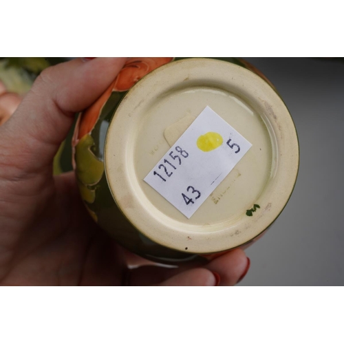 47 - A pair of Moorcroft green ground Hibiscus pattern dwarf candlestick together with a table bell and a... 