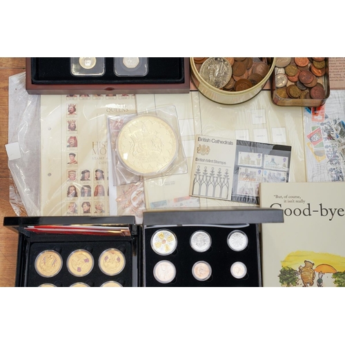 1106 - A box of assorted commemorative and circulated  coins and stamps, in presentation packs and loose, i... 