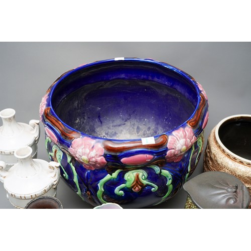 21 - A large Victorian blue glazed jardiniere, relief moulded with flowers (af), together with a pair of ... 