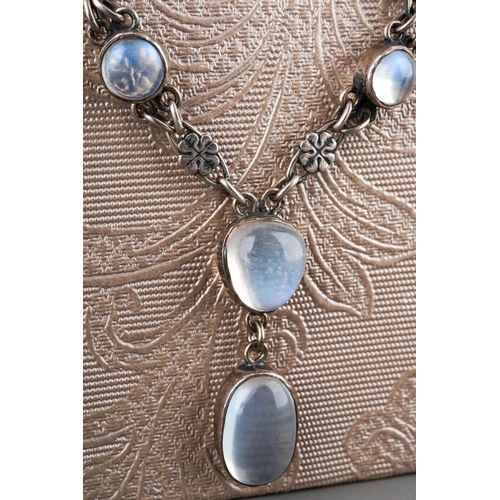 92 - A silver and moonstone necklace, set with fifty one oval moonstones, flowerhead shaped links, no cla... 