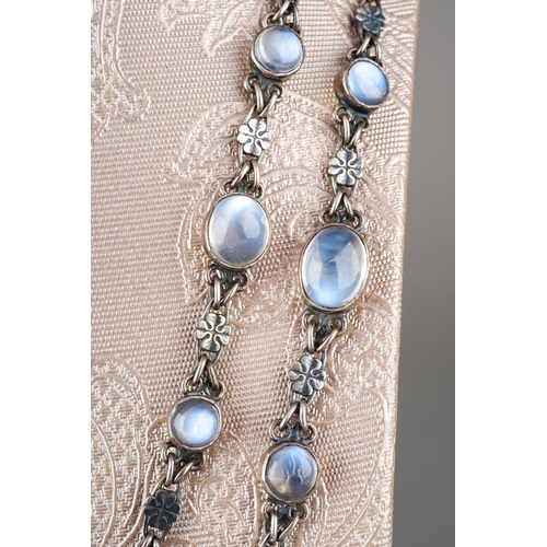 92 - A silver and moonstone necklace, set with fifty one oval moonstones, flowerhead shaped links, no cla... 