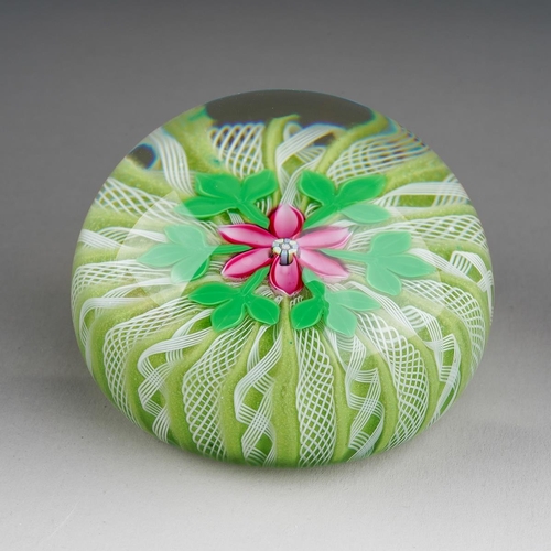 A Perthshire glass millefiori domed paperweight , pink flowerhead to centre surrounded by six trefoil leaves, with radiating latticino white twists on a green cushion, cane to base 1998 P, diameter 65mm