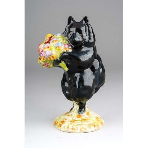 A Beatrix Potter Beswick figure of Duchess modelled as a black dog holding a bouquet of flowers, F Warne & Co. Limited and gold back stamps, BP-2 oval stamp, 10 cm high [1]