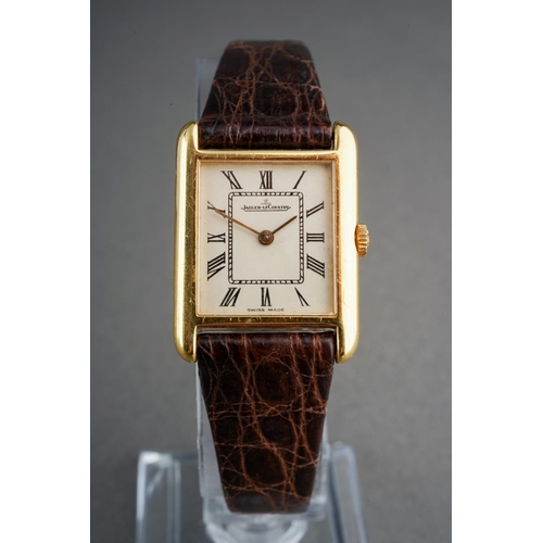 A JAEGER-LECOULTRE WRISTWATCH. The white dial, with black Roman numerals, dial signed 'Jaeger-Le Coultre Swiss Made', Swiss control marks for 18ct gold, case back numbered 140 056 1541955 approx case diameter 20mm by 27mm (including lugs), the watch is not currently winding - in need of attention, we can not guarantee the accuracy or working order of any watch sold, gross weight 19.2 grams.