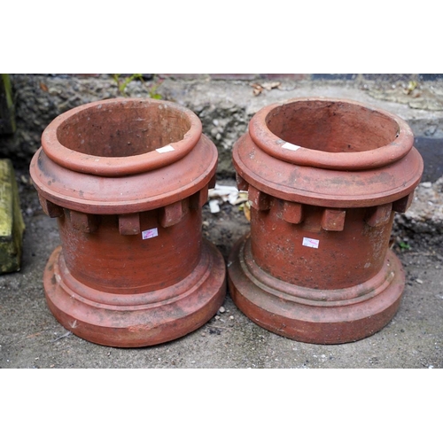 815 - A pair of terracotta chimney pots of cylindrical form with dentil style decoration below the top rim... 