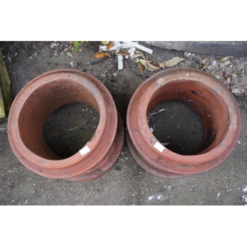 815 - A pair of terracotta chimney pots of cylindrical form with dentil style decoration below the top rim... 