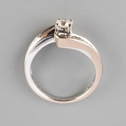 38 - An 18ct white gold diamond cross over ring. Set with round brilliant cut diamonds. Approx ring size ... 