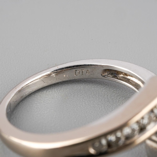 38 - An 18ct white gold diamond cross over ring. Set with round brilliant cut diamonds. Approx ring size ... 