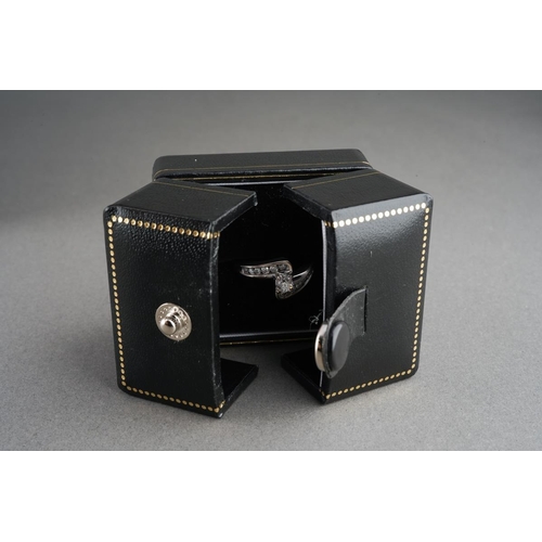 38 - An 18ct white gold diamond cross over ring. Set with round brilliant cut diamonds. Approx ring size ... 