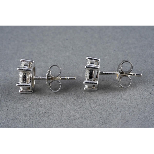 39 - A pair of 18ct white gold diamond cluster earrings. Each ear stud set throughout with round brillian... 