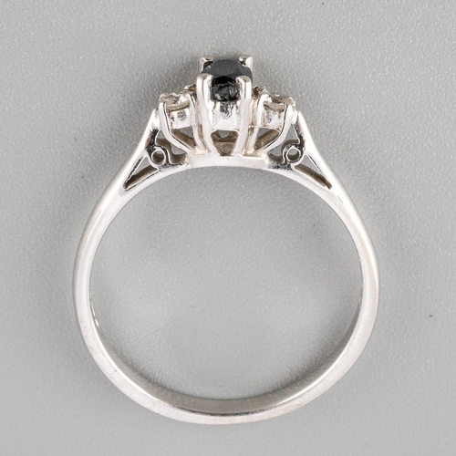 42 - A 9ct gold sapphire and diamond three stone ring. Set with an oval shape sapphire, flanked to each s... 