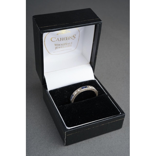 49 - An 18ct white gold diamond and sapphire eternity ring. Set with single-cut diamonds, grain set and c... 