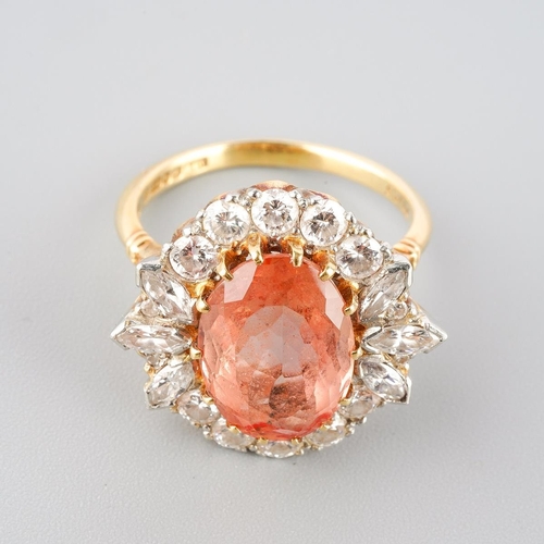 A 1970s 18ct gold tourmaline and diamond cluster ring. The oval-shape tourmaline, with a diamond set border. Estimated total diamond weight 1.00ct, hallmarked 18ct gold Birmingham, 1975, sponsors mark A&W (Alabaster and Wilson), inner shank numbered 62486, approx ring size O, approx gross weight 8.07 grams.