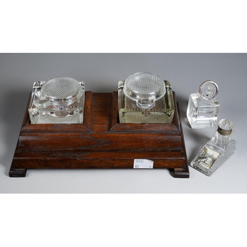 385 - A 1930s stained oak inkstand with a pair of moulded glass bottles together with two early 20th Centu... 