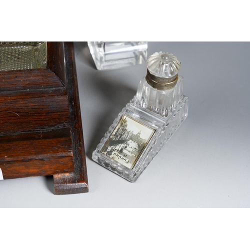 385 - A 1930s stained oak inkstand with a pair of moulded glass bottles together with two early 20th Centu... 