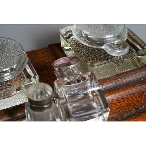 385 - A 1930s stained oak inkstand with a pair of moulded glass bottles together with two early 20th Centu... 