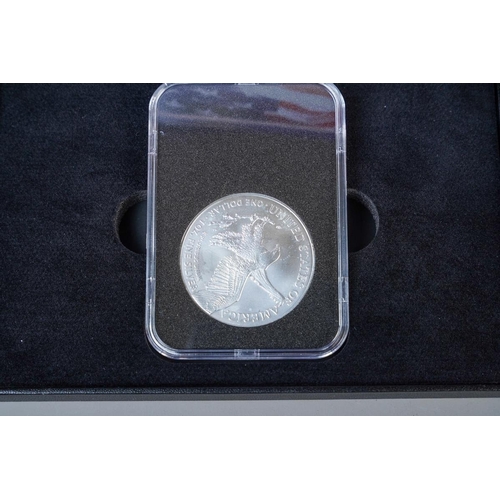 392 - A boxed and cased 2024 U.S. 1oz silver eagle coin in perspex case, with certificate, together with a... 