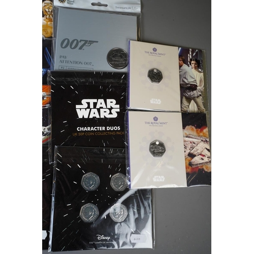 393 - A small collection of coins and stamps relating to popular culture / TV / Film, including a Marvel X... 