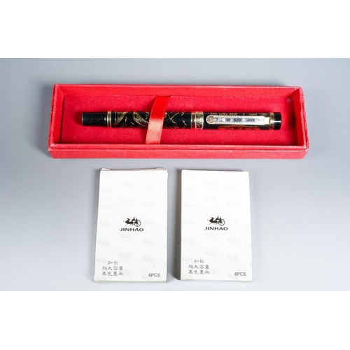 414 - A boxed Chinese Jinhao black and gilt metal Fountain Pen, the barrel decorated with landscape, the c... 