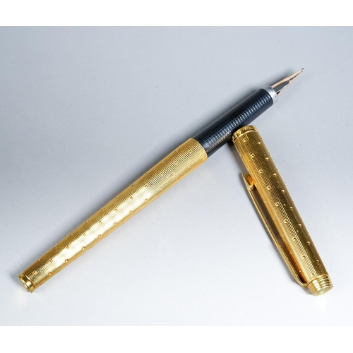 415 - A Parker 180 gold plated fountain pen, the barrel and cap engine turned with dot decoration, the nib... 