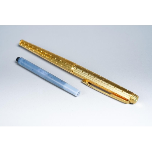 415 - A Parker 180 gold plated fountain pen, the barrel and cap engine turned with dot decoration, the nib... 