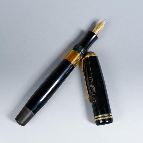 419 - A vintage Montblanc black and gilt fountain pen, the nib stamped 14k and 1., with Mountain logo etch... 