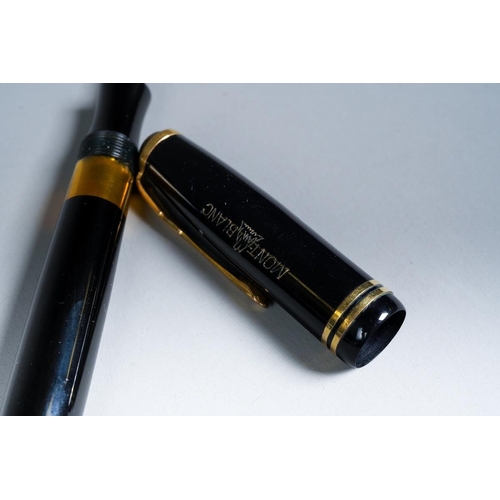 419 - A vintage Montblanc black and gilt fountain pen, the nib stamped 14k and 1., with Mountain logo etch... 