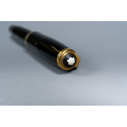 419 - A vintage Montblanc black and gilt fountain pen, the nib stamped 14k and 1., with Mountain logo etch... 