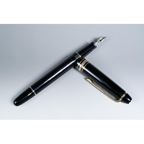 421 - A Montblanc Meisterstuck black and gilt Fountain pen with two-tone 14k gold nib stamped 4810, the cl... 