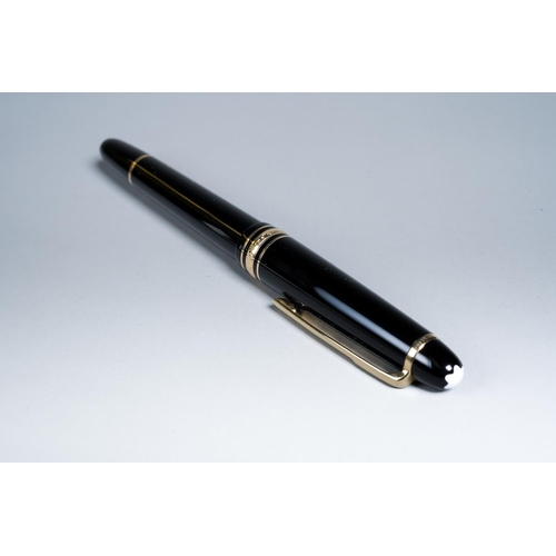 421 - A Montblanc Meisterstuck black and gilt Fountain pen with two-tone 14k gold nib stamped 4810, the cl... 