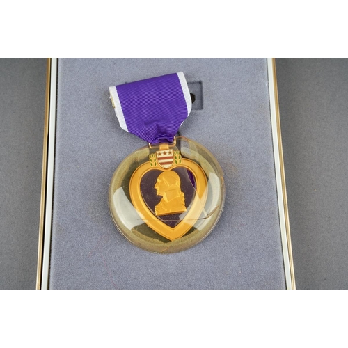 19 - US Purple Heart in case of issue along with matching ribbon bar and enamel lapel ribbon.