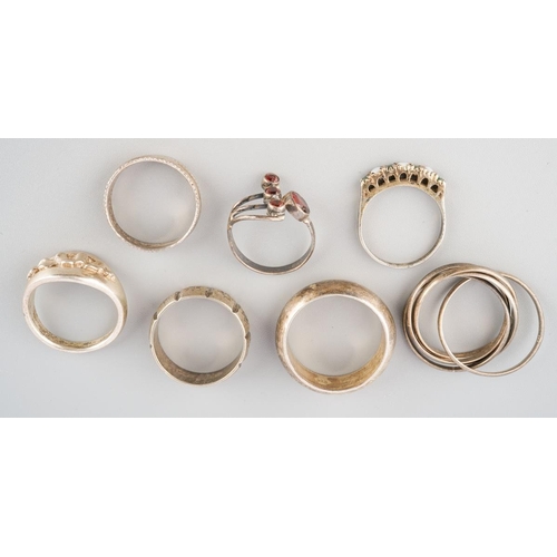 A group of white metal rings. To include seven rings, each ring with ...