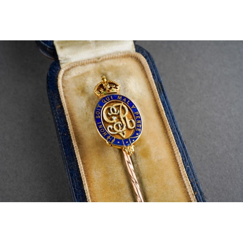 18 - A King George V yellow metal and Enamel Stick Pin. The head tests as 18ct, the pin tests as 9ct. 
Ho... 