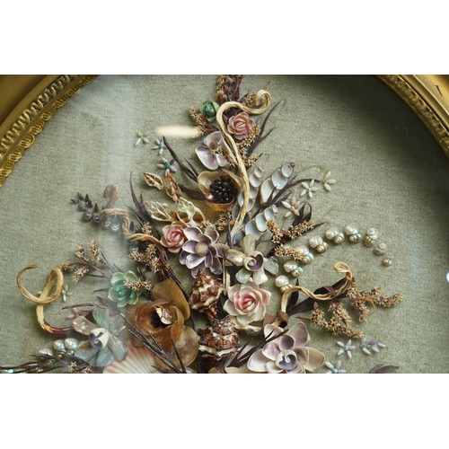 37 - A late 20th Century oval gilt framed shell picture, in the form of a bouquet of flowers, bears shell... 