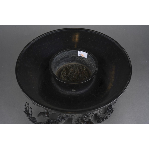 44 - A two section bronze centrepiece, the upper section of circular form with internal thread, the base ... 