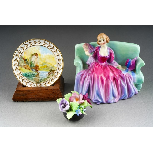 256 - An early 20th Century Royal Crown Derby circular small plaque painted with Highland Scene, signed by... 