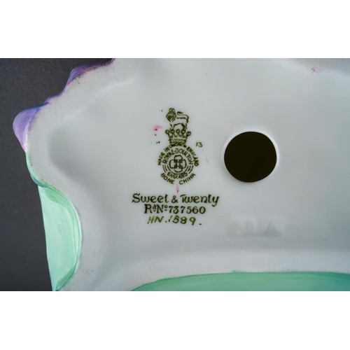 256 - An early 20th Century Royal Crown Derby circular small plaque painted with Highland Scene, signed by... 
