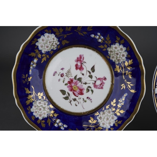 265 - Two early 19th century English porcelain hand painted dessert plates, both with blue and gilt border... 
