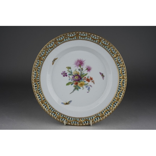 266 - A KPM cabinet plate, the pierced rim with gilt swag design on blue bars, the centre painted with a f... 