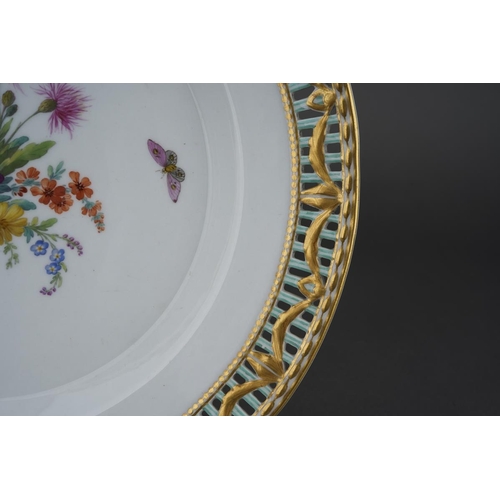 266 - A KPM cabinet plate, the pierced rim with gilt swag design on blue bars, the centre painted with a f... 
