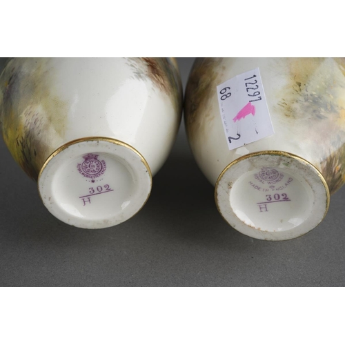 274 - A pair of Royal Worcester ovoid vases painted with cock and hen pheasants on an ivory ground by Jame... 