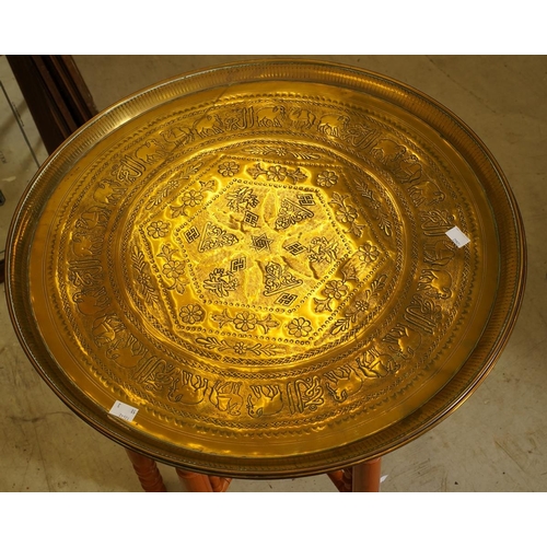74 - Two Asian engraved copper circular table tops, approx 58cm diam together with a modern turned base [... 
